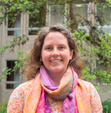 Headshot of Dr Judith Krauss, with an orange and pink scarf round her neck